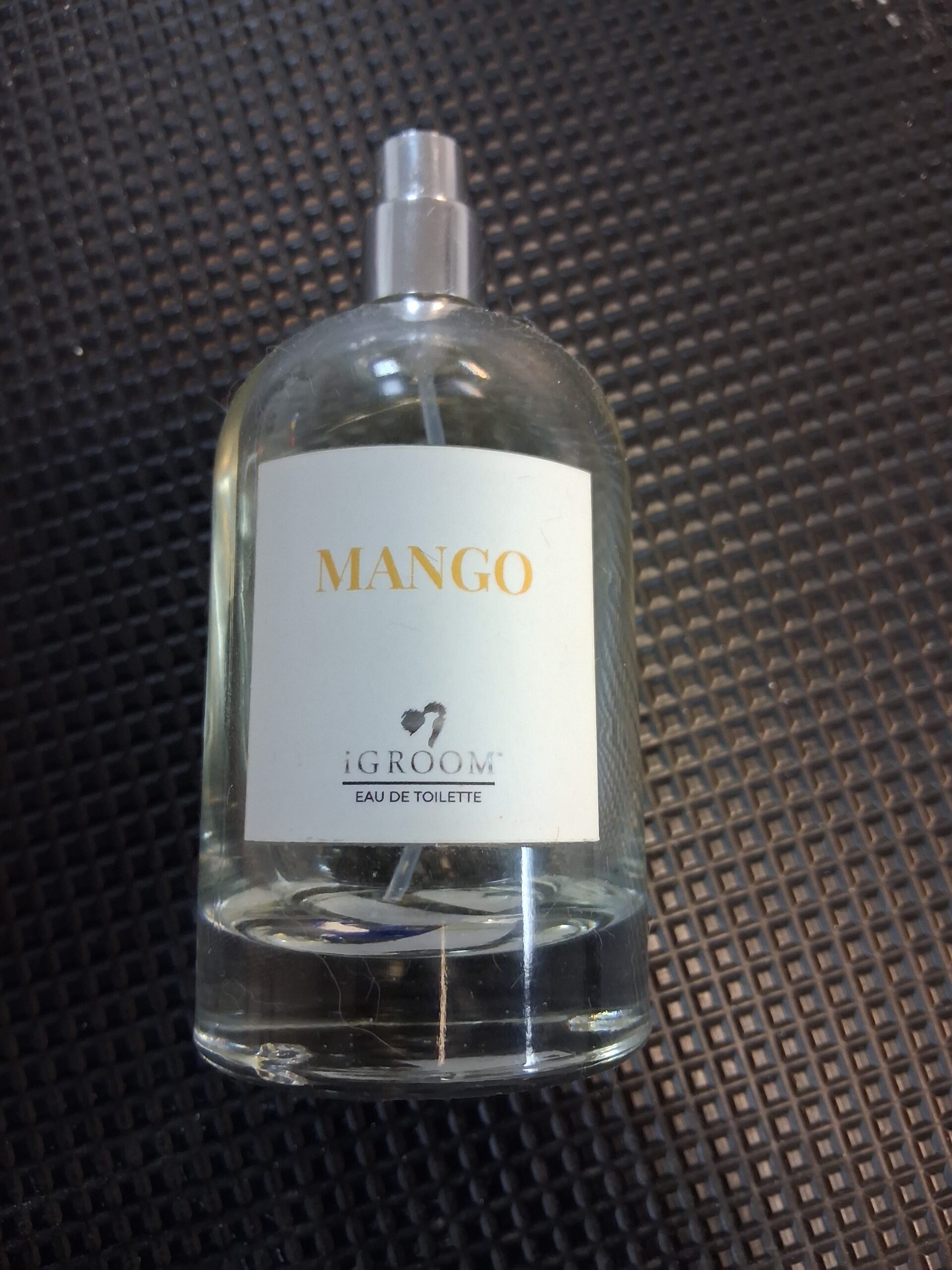 iGroom Mango Eau De Toilette bottle on a black grooming mat